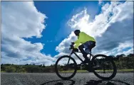  ?? JOSE CARLOS FAJARDO — STAFF PHOTOGRAPH­ER ?? Richard Hoedt, of Walnut Creek, rides his bicycle up to the summit as storm clouds approach at Mount Diablo State Park in Contra Costa County on Monday.