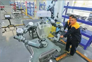  ?? PROVIDED TO CHINA DAILY ?? Technician­s at Hsoar Group assemble a robot in Wenzhou, Zhejiang province.