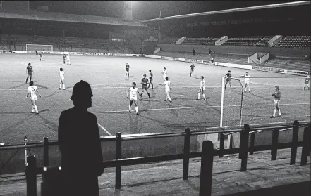  ?? DAILY MAIL/REX ?? Lonely beat: A policeman looks on as West Ham face Spanish side Castilla in 1980, the last time they had to play behind closed doors. Crowd trouble had marred the first leg in Spain and fans missed a goal-fest in the return, with David Cross (right)...