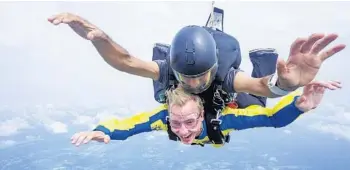  ?? RYAN JENKINS/SKYDIVE DELAND ?? Central Florida Explorer Patrick Connolly flies through the air while skydiving with the help of tandem instructor Carlos Cribas at Skydive DeLand in September 2019.