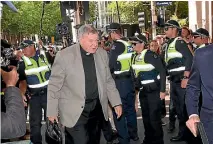  ?? PHOTO: FAIRFAX ?? Cardinal George Pell walks to court on the first day of a committal hearing on sex abuse charges at the Melbourne Magistrate­s Court.