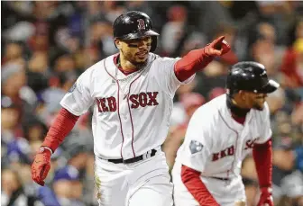  ?? Maddie Meyer / ?? Boston’s Mookie Betts celebrates scoring a run during Game 2 on Wednesday night at Fenway Park. The Red Sox, up 2-0 in the series, have scored 10 of their 12 runs with two outs.