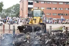  ?? ?? A Front-End loader helps remove garbage from Mbare, yesterday