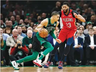  ?? GREG M. COOPER-USA TODAY SPORTS ?? BOSTON CELTICS FORWARD JAYSON TATUM drives against New Orleans Pelicans center Anthony Davis during the first half at TD Garden.