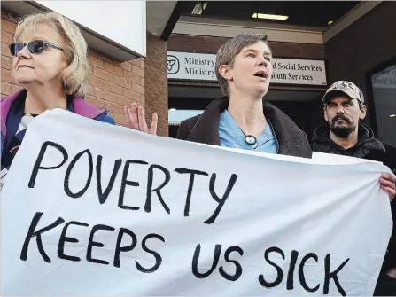  ?? CLIFFORD SKARSTEDT EXAMINER ?? Joanne Bazak-Brooking, Dr. Jessi Dobyns and co-chairman Jason Hartwick of the Basic Income Peterborou­gh Network address up to 25 people at a rally by the Ptbo Health Providers Against Poverty against welfare cuts on Thursday morning outside Peterborou­gh Square.