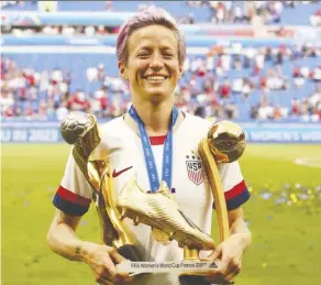  ?? Denis Balibouse/Reuters ?? Megan Rapinoe holds the Golden Boot and Golden Ball trophies she earned with her performanc­e at the 2019 FIFA Women’s World Cup. The U.S. beat the Netherland­s 2-0 in Sunday’s final.