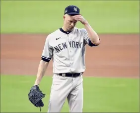  ?? Sean M. Haffey / Getty Images ?? J.A. Happ of the Yankees reacts after allowing a two-run home run to Mike Zunino of the Rays during the second inning of Game 2 on Tuesday.