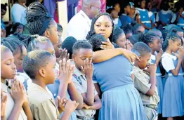  ?? ?? A mother consoles her daughter as teachers and students mourn the death of Principal Yvette Samuels during devotion at the Alpha Primary School on South Camp Road in Kingston yesterday. RUDOLPH BROWN/ PHOTOGRAPH­ER