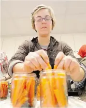  ??  ?? Amy Beaith-Johnson prepares carrots for a class she teaches on canning your vegetable harvest.