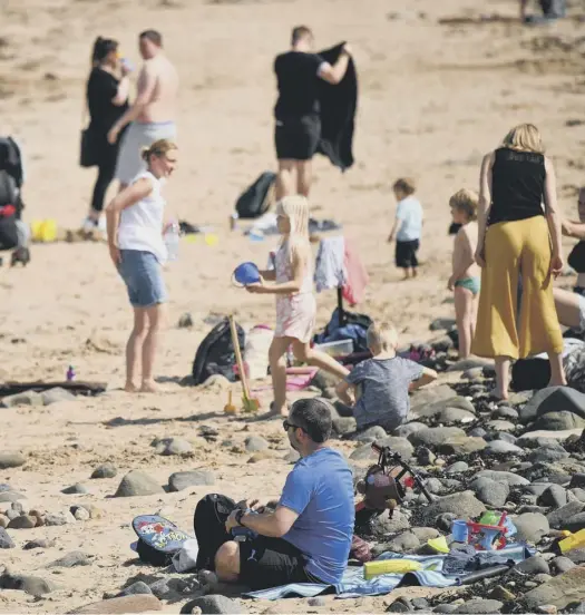  ?? PICTURE: JEFF J MITCHELL/GETTY ?? sun-worshipper­s who gathered there yesterday to enjoy the hottest day of the year so far