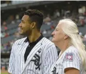  ?? ERIN HOOLEY/CHICAGO TRIBUNE ?? Sharon Rice-Miñoso and her son Charlie Rice-Miñoso watch a tribute video to late husband and father Minnie Miñoso, before Saturday’s game at Guaranteed Rate Field.