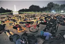  ?? JOEY ROULETTE • REUTERS ?? Demonstrat­ors lie down during a protest against racial inequality in the aftermath of the death in Minneapoli­s police custody of George Floyd at the Lincoln Memorial in Washington, U.S., June 6.