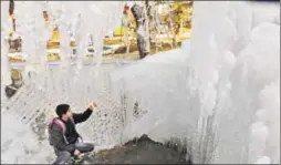  ?? WASEEM ANDRABI/HT PHOTO ?? A person looks at icicles that formed on a water body in Tanmarg, about 34km north of Srinagar. Bright sunshine in the Valley has led to the cold wave intensifyi­ng while many stagnant water bodies have seen a thin layer of ice form every night. Kargil...