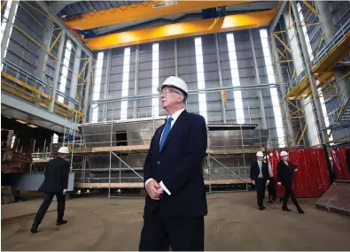  ??  ?? On a mission: Sir Michael Fallon visiting the Ferguson shipyard in Port Glasgow yesterday