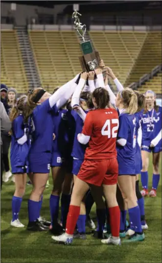  ?? KYLE SOOY — FOR THE MORNING JOURNAL ?? Bay proudly hoists its runner-up trophy after falling to Cincinnati Indian Hill in the Division II state final at MAPFRE Stadium on Nov. 9.
