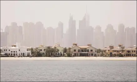 ??  ?? In this file photo, Jumeirah Palm Island luxury villas are seen by their private beaches in Dubai, United Arab Emirates. Dubai’s ruler has issued a directive
to curb the pace of new real estate constructi­on projects amid falling demand and property prices. (AP)