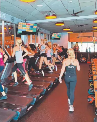  ?? Provided by Orangetheo­ry Fitness ?? Orangetheo­ry Fitness are franchised studios run on a class-based schedule with hour-long sessions that cycle members through TRX stations, rowing machines and treadmills, all guided by an instructor.