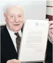  ??  ?? Former Australian prime minister Gough Whitlam with the original copy of his dismissal letter in 2005.