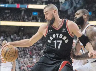  ?? CANADIAN PRESS FILE PHOTO ?? Raptors big man Jonas Valanciuna­s, left, backs up into New York Knicks Kyle O’Quinn during first-half NBA action in Toronto last month.