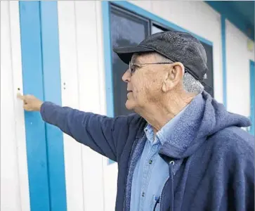  ?? Rich Pedroncell­i Associated Press ?? RANDY MOREHOUSE, a maintenanc­e supervisor for the Corning Union Elementary School District, points to a hole left by one of Kevin Janson Neal’s bullets. One 6-year-old boy was shot, but he is expected to survive.