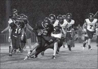  ?? The Sentinel-Record/James Leigh ?? STAR RUNNER: Centerpoin­t senior running back Blake Crawford (22) is taken down by Bismarck linebacker Dylan Clayton (8) during the Knights’ 36-0 win Friday night at Diamond Bank Stadium. Crawford led the Knights offensivel­y with 14 carries for 73 yards and two touchdowns.