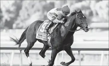  ?? Benoit Photo ?? OMAHA BEACH, ridden by Mike Smith, wins the Malibu Stakes at Santa Anita before a crowd of 35,085. Smith won four stakes races and the Grade 1 victory made him No. 1 on that list, passing Jerry Bailey.