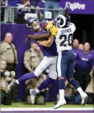  ?? BRUCE KLUCKHOHN — THE ASSOCIATED PRESS ?? Los Angeles Rams free safety Lamarcus Joyner (20) breaks up a pass intended for Minnesota Vikings wide receiver Adam Thielen during the first half of an NFL football game, Sunday in Minneapoli­s.