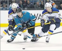  ?? NHAT V. MEYER — STAFF PHOTOGRAPH­ER ?? The Sharks’ Joonas Donskoi can’t quite get a shot off against St. Louis Blues’ Carl Gunnarsson, left, and Oskar Sundqvist on Thursday night.