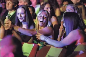  ?? SHANE FLANIGAN/THISWEEK ?? Dublin Jerome’s Raegan Ernst shares a laugh with fellow athletes at the Central Ohio High School Sports Awards at the Ohio Theatre. Ernst was named the overall Female Athlete of the Year and Gymnastics Athlete of the Year.