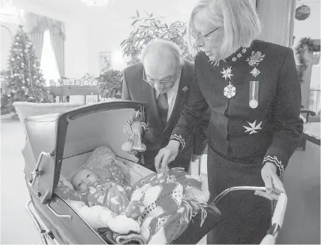  ?? ADRIAN LAM, TIMES COLONIST ?? Lt.-Gov. Judith Guichon and her husband, Bruno Mailloux, greet four-month-old Greta Grant in the receiving line at Monday’s New Year’s Day levee at Government House. Greta was enjoying the festivitie­s with her parents and grandmothe­r.