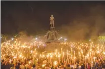  ?? EDU BAYER / THE NEW YORK TIMES ?? Neo-nazis and white supremacis­ts rally Aug. 11, 2017, on the grounds of the University of Virginia in Charlottes­ville, Va.. People injured at the alt-right rally the following day say in a lawsuit that organizers conspired to incite violence. The...