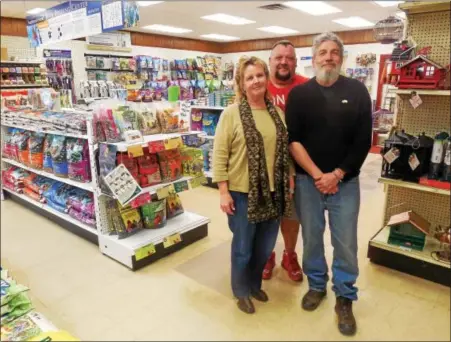  ?? VIRGINIA LINDAK — FOR THE PHOENIX ?? Pughtown Agway owners Anna and Aldo Magazzeni with manager Arnie Ledford (in back) show off the newly expaded feed store showroom.