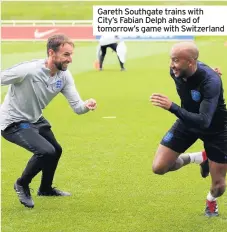  ??  ?? Gareth Southgate trains with City’s Fabian Delph ahead of tomorrow’s game with Switzerlan­d
