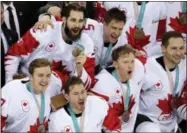  ?? THE ASSOCIATED PRESS ?? Canada hockey team celebrate with their bronze medals after beating the Czech Republic in the men’s bronze medal hockey game at the 2018 Winter Olympics in Gangneung, South Korea, Saturday.