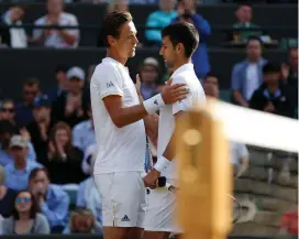  ?? REUTERS ?? COMMISERAT­IONS: Serbia’s Novak Djokovic, right, is consoled by the Czech Republic’s Tomas Berdych as he retires injured from their quarter-final match.