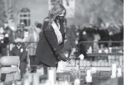  ?? SHOLTEN SINGER The Herald-Dispatch via AP ?? Mourners place white roses on the edge of the Memorial Fountain on Saturday in Huntington, W.Va., to honor the 75 lives lost in the 1970 plane crash. Most of the Marshall football team and staff were on the doomed flight.