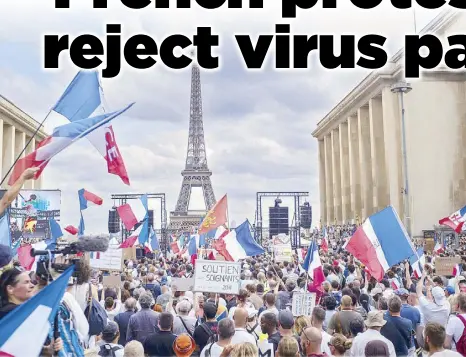  ?? AP ?? Thousands of demonstrat­ors protest against tougher regulation­s to contain COVID-19 at Place Trocadero near the Eiffel Tower in Paris on Saturday.