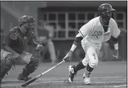  ?? NWA Democrat-Gazette/ANDY SHUPE ?? Northwest Arkansas Naturals left fielder Khalil Lee connects for an RBI single to score designated hitter Anderson Miller.