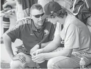  ??  ?? Second Baptist assistant coach Andy Pettitte offers pitcher Zachary Heaton the voice of experience.
