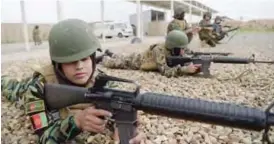  ??  ?? KABUL: In this photograph, Afghan National Army (ANA) female soldiers use rifles on a range during a live firing exercise at the Kabul Military training centre (KMTC) on the outskirts of Kabul. — AFP