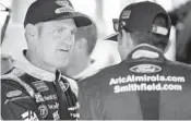 ?? COLIN E. BRALEY/AP ?? Clint Bowyer, left, talks with Aric Almirola before the Hollywood Casino 400 at Kansas Speedway last week.