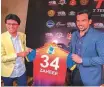  ?? Bengal Tigers ?? Anis Sajan presents team jersey to Zaheer Khan at a promotiona­l event.