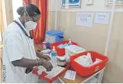  ??  ?? TESTING THE SYRINGE: A health official takes part in dry run for Covid-19 vaccine delivery in Hyderabad yesterday.