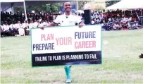  ?? ?? A member of Iyasa drama and dance group displays a placard encouragin­g schoolchil­dren to take their school work seriously and to plan on the careers they need to take upon completion of school during a career guidance, grooming, etiquette and stay in school programme organised by First Lady Dr Auxillia Mnangagwa in Mashonalan­d East on Monday