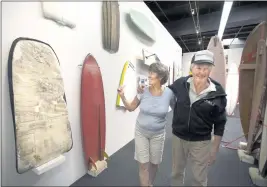  ?? ED CRISOSTOMO — STAFF PHOTOGRAPH­ER ?? Morey shares a laugh with his wife, Marchia, as they walk through an exhibit of his Boogie board creations at the Surfing Heritage and Culture Center in San Clemente in 2015.