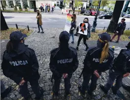  ?? CZAREK SOKOLOWSKI — THE ASSOCIATED PRESS ?? Pro-choice activists from “Women Strike” attend a protest in front of Poland’s constituti­onal court in Warsaw, Poland, on Thursday.