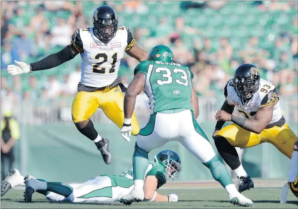  ?? — TROY FLEECE/REGINA LEADER-POST FILES ?? Linebacker Simoni Lawrence, left, and the Hamilton Tiger-Cats’ defence have slammed the door on running backs in the CFL season so far. The Ticats are looking to ground high-flying Andrew Harris of the B.C. Lions Saturday.