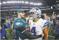  ?? ASSOCIATED PRESS FILE PHOTO ?? The Eagles’ Carson Wentz, left, and the Cowboys’ Dak Prescott greet each other after their Nov. 11 game. Prescott and the Cowboys saved their season with a win in Philadelph­ia a month ago. Now Carson Wentz and the defending champion Eagles are trying to do the same in Texas against first-place Dallas on Sunday.