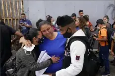  ?? Gregory Bull/Associated Press ?? Lizeth Morales, left, of Honduras, and her son, Alex Cortillo, right, get a hug from Erika Valladares Ponce, as they wait in Tijuana, Mexico, to cross into the United States to begin the asylum process.