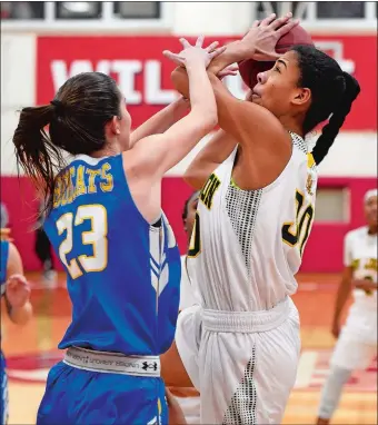  ?? SEAN D. ELLIOT/THE DAY ?? New London’s Tai Pagan is fouled by Bacon Academy’s Taylor Rochette (23) during the first half of Tuesday’s ECC Division I girls’ basketball title game at NFA’s Alumni Gym. The Whalers won their third straight championsh­ip with a 54-40 win. Visit www.theday.com to view a photo gallery.